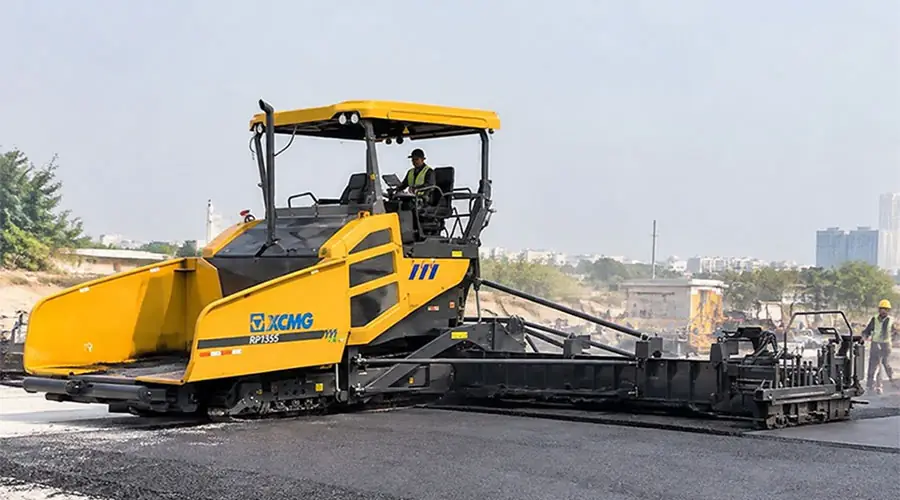An XCMG RP1355 asphalt paver machine operating on a road construction site, representing the ultimate buying guide for paving equipment.
