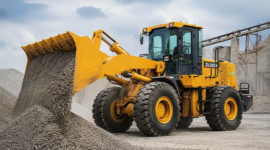 A powerful yellow XCMG ZL50GN 5-ton wheel loader discharging gravel onto a stockpile, showcasing its productivity and heavy-duty performance.